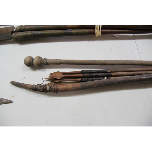 2081 - African: a bow, approx 117cm long; together with five metal tipped arrows; and a wooden stick. (7)