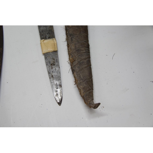 2085 - African: a knife having carved wood handle and snakeskin scabbard, approx 48cm long.