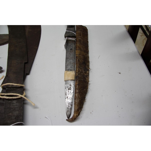 2085 - African: a knife having carved wood handle and snakeskin scabbard, approx 48cm long.