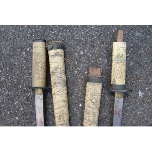 2096 - Two Japanese swords, having carved bone scabbards and copper mounted handles, (a.f).