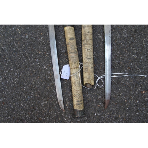 2096 - Two Japanese swords, having carved bone scabbards and copper mounted handles, (a.f).