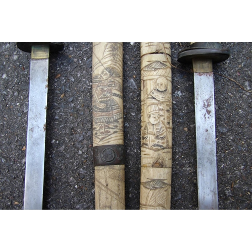 2096 - Two Japanese swords, having carved bone scabbards and copper mounted handles, (a.f).