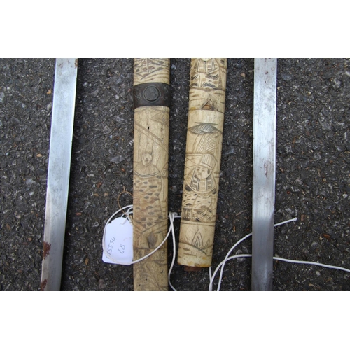 2096 - Two Japanese swords, having carved bone scabbards and copper mounted handles, (a.f).