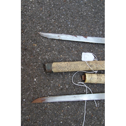 2096 - Two Japanese swords, having carved bone scabbards and copper mounted handles, (a.f).