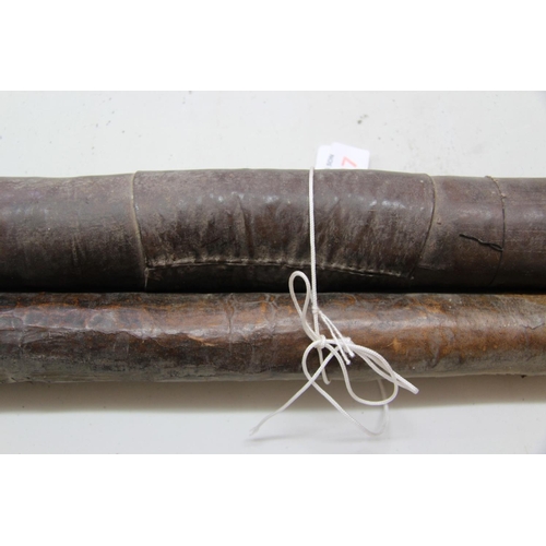 2097 - African: two leather quivers, 71cm and 86cm long containing barbed metal poisoned arrows, .