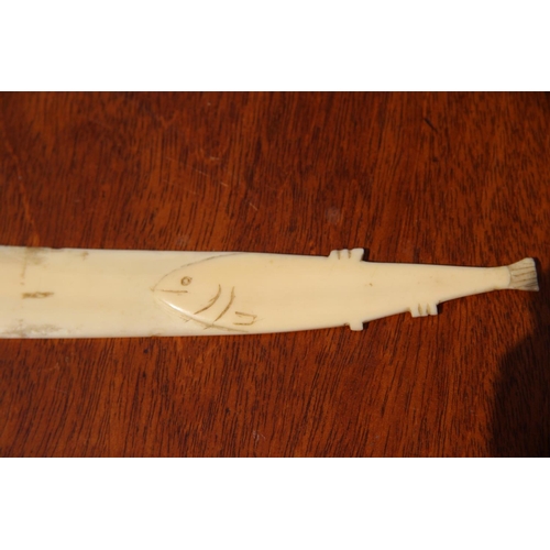 2109 - An Inuit style ivory small knife, probably marine ivory, with fish form handle, 23cm long.