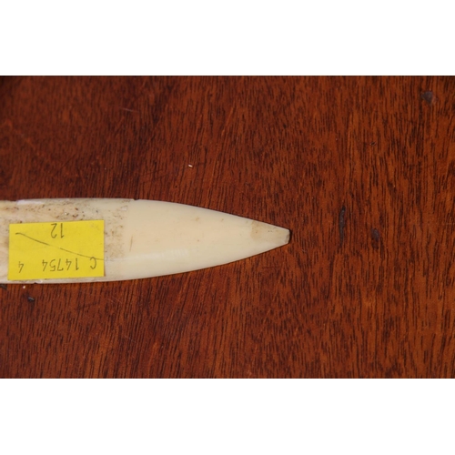 2109 - An Inuit style ivory small knife, probably marine ivory, with fish form handle, 23cm long.