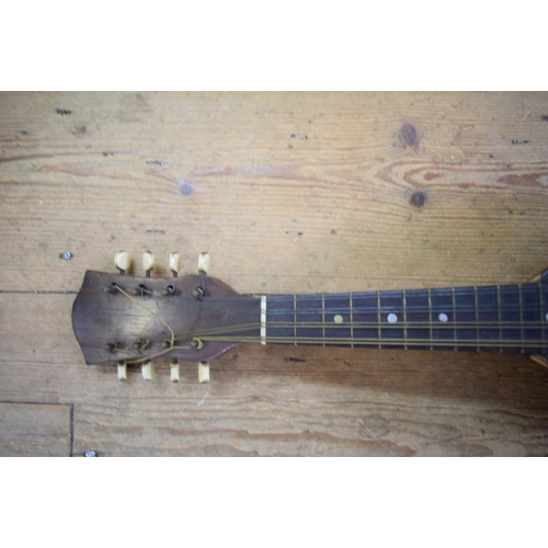 1866 - A rosewood and inlaid mandolin, cased.