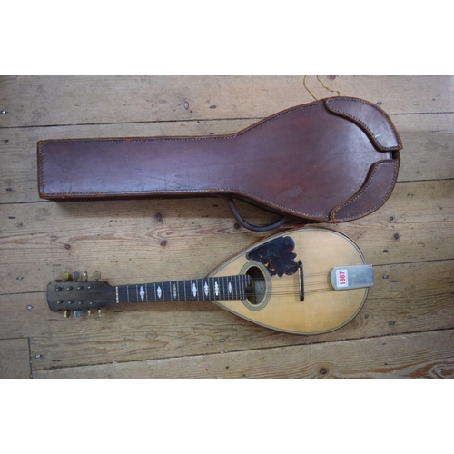 1867 - A flatback mandolin, labelled and inscribed 'John E Dallas', and numbered 4733, in tan leather case.