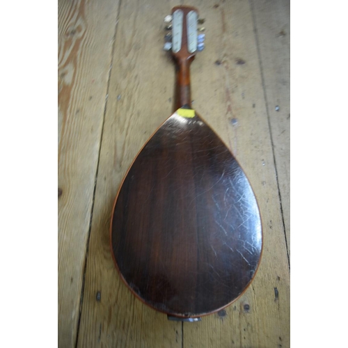 1867 - A flatback mandolin, labelled and inscribed 'John E Dallas', and numbered 4733, in tan leather case.