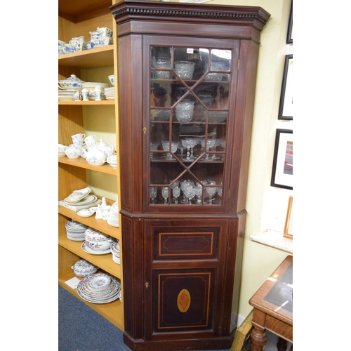 1875 - A late 18th century mahogany and inlaid standing corner cupboard, with astragal glazed door to the t... 