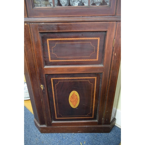 1875 - A late 18th century mahogany and inlaid standing corner cupboard, with astragal glazed door to the t... 