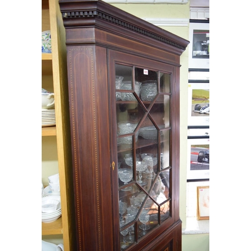 1875 - A late 18th century mahogany and inlaid standing corner cupboard, with astragal glazed door to the t... 