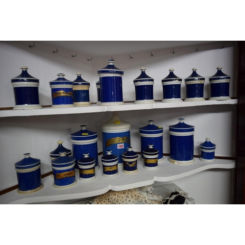 1926 - A collection of twenty-two Victorian blue and white pottery apothecary jars and covers, largest 25cm... 