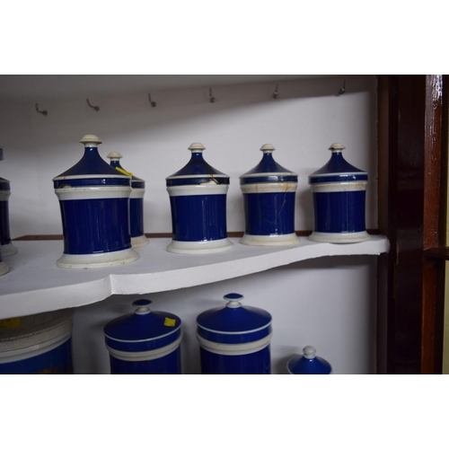 1926 - A collection of twenty-two Victorian blue and white pottery apothecary jars and covers, largest 25cm... 