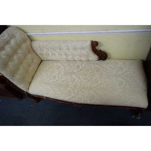 1931 - A reproduction button upholstered chaise longue, in damask fabric.