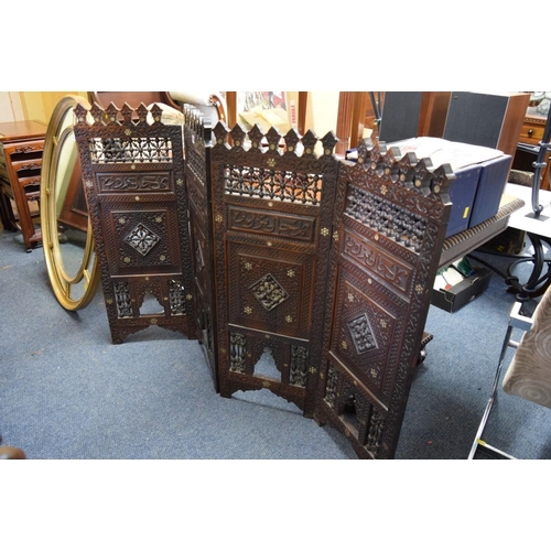 1948 - An ottoman carved and pierced wood mashrabiya four fold screen, 94cm high x 139cm wide.