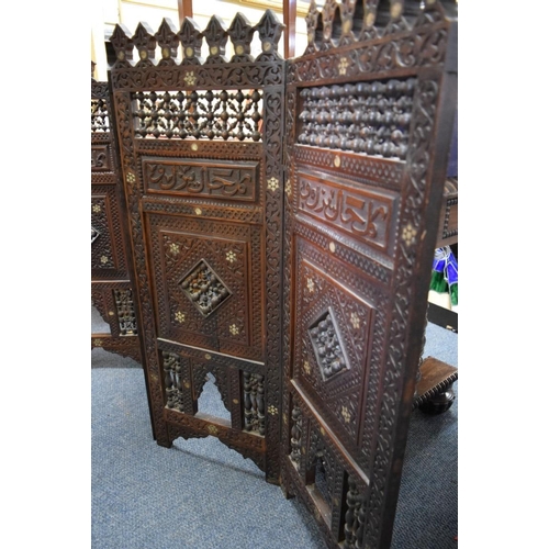 1948 - An ottoman carved and pierced wood mashrabiya four fold screen, 94cm high x 139cm wide.