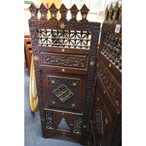 1948 - An ottoman carved and pierced wood mashrabiya four fold screen, 94cm high x 139cm wide.