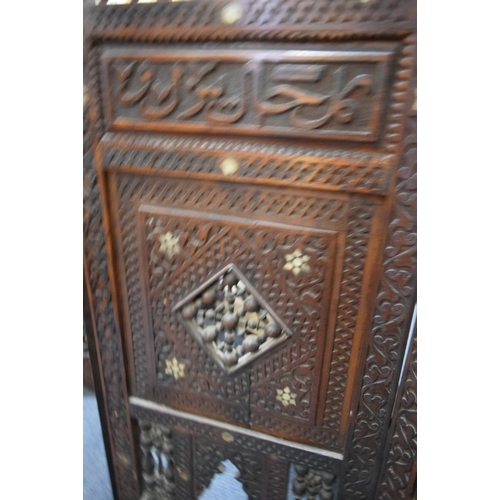 1948 - An ottoman carved and pierced wood mashrabiya four fold screen, 94cm high x 139cm wide.