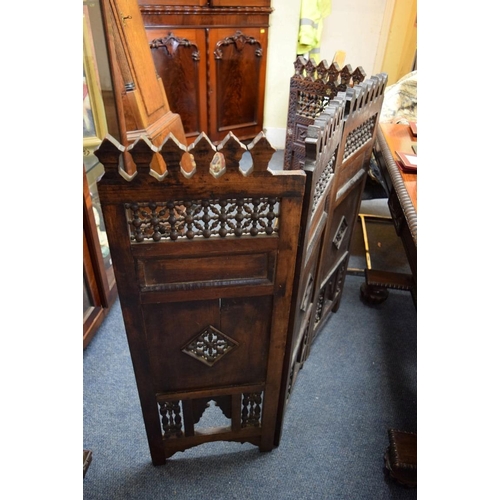 1948 - An ottoman carved and pierced wood mashrabiya four fold screen, 94cm high x 139cm wide.