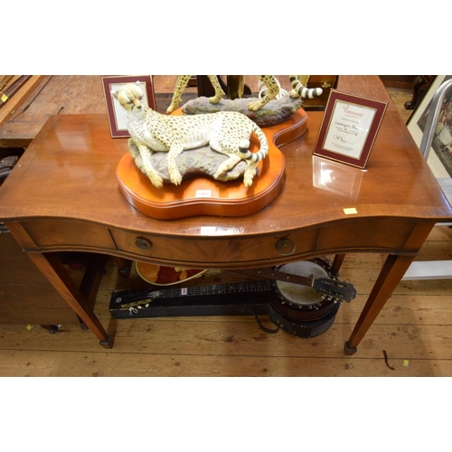 1967 - A reproduction mahogany and crossbanded serpentine fronted serving table, 107.5cm wide.