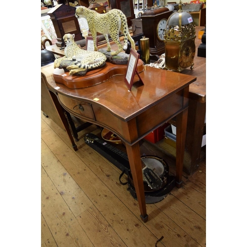 1967 - A reproduction mahogany and crossbanded serpentine fronted serving table, 107.5cm wide.