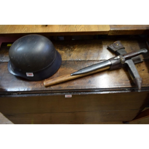 1969 - A German Third Reich Luftschutz combat helmet; together with a K98 bayonet and escape axe, in leathe... 