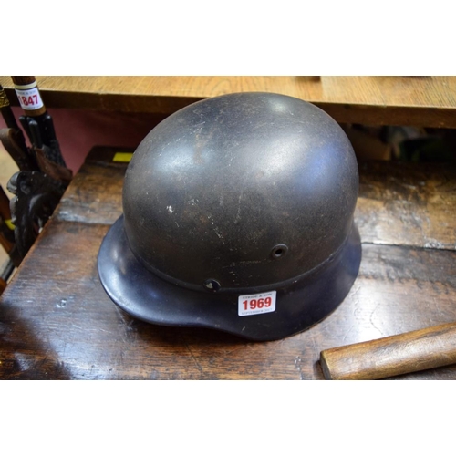 1969 - A German Third Reich Luftschutz combat helmet; together with a K98 bayonet and escape axe, in leathe... 