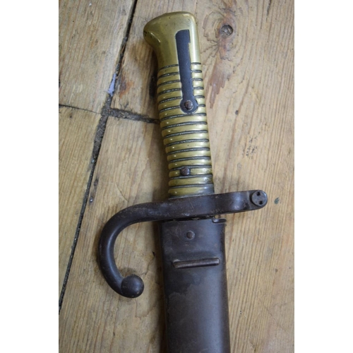 1972 - A French bayonet and steel scabbard, the blade inscribed and dated 1873, total length 72cm.