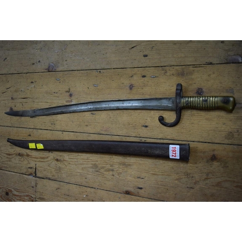 1972 - A French bayonet and steel scabbard, the blade inscribed and dated 1873, total length 72cm.