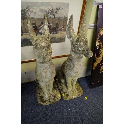 1823 - A pair of composition stone Egyptian dogs, 84cm high.