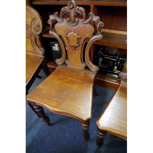 1841 - A late Regency mahogany hall chair; together with another pair of Victorian mahogany hall chairs.