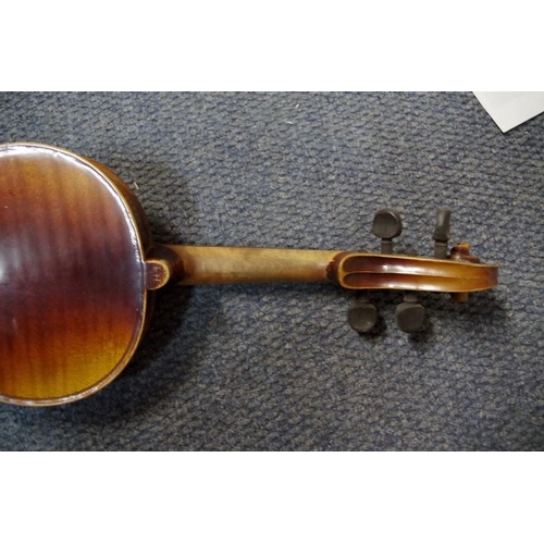 1850 - An old violin, with 14 in back, cased and with two bows; together with another small violin, case an... 