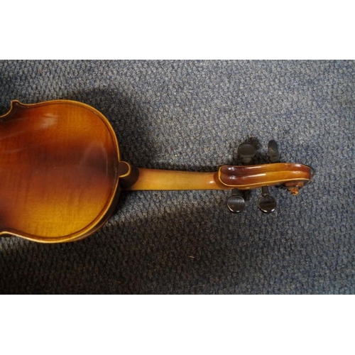 1850 - An old violin, with 14 in back, cased and with two bows; together with another small violin, case an... 