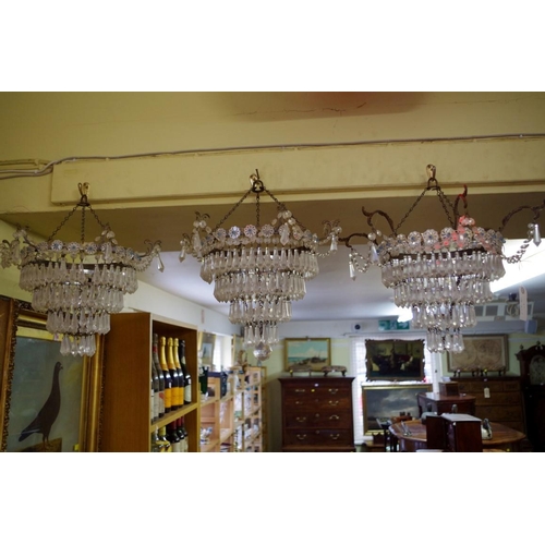 1870 - A set of three four tier chandeliers.