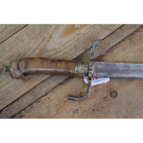 1915 - An 18th/19th century sabre sword, the burr wood pistol grip handle with brass mounts, total length 7... 