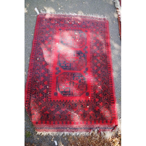 1194 - A Bokhara rug, having floral and geometric design; together with another Bokhara rug having three ce... 