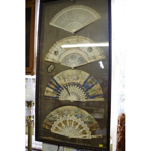 1752 - A framed display of four 19th century fans, to include a Chinese ivory brise example, the guards 27c... 