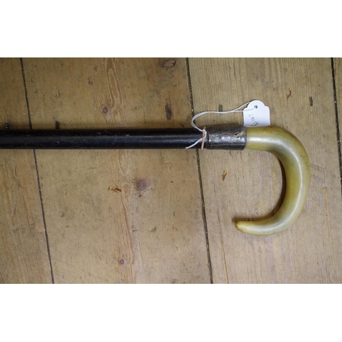 1828 - A horn handled and silver mounted ebonized walking stick.