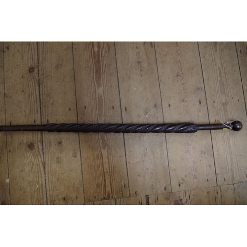 1830 - A novelty carved wood walking cane, the shaft carved in relief with five spiralled serpents.... 