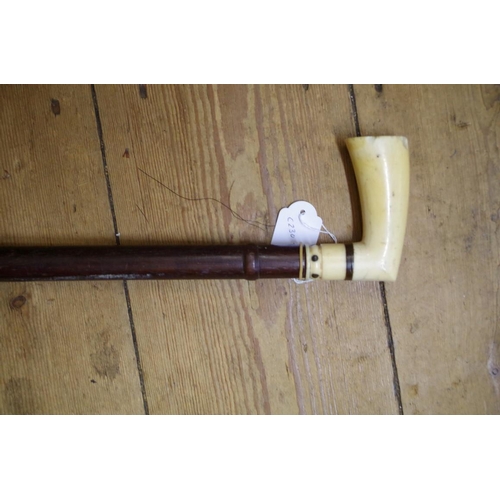 1833 - An antique ivory handled hardwood walking stick, with bone inlay to the handle.