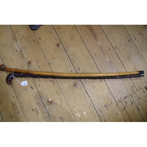 1841 - A novelty carved wood walking cane, inscribed 'W. Halliday'; together with another novelty carved wo... 