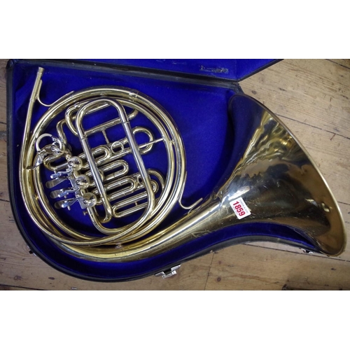 1859 - An old brass French horn, inscribed Amborg, Como, cased.