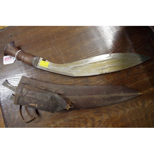 1882 - A kukri and leather sheath. 