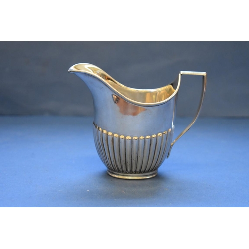 11 - A Victorian silver creamer, by W Hutton & Sons Ltd, London 1894, indistinct makers mark, 129g.... 