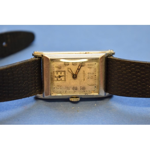 66 - A 1940s Jaeger Le Coultre gentlemans tank watch, case number 202559 on black leather strap.... 