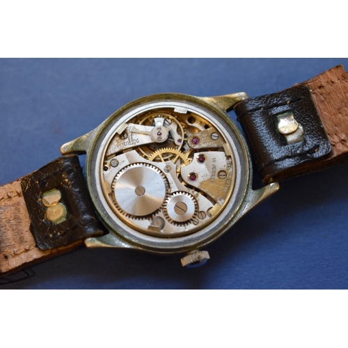 68 - A World War ll era ATP military wristwatch, by Bravington, on leather strap.