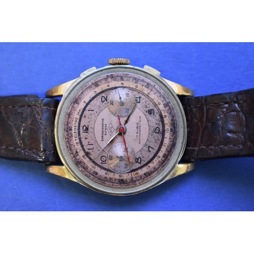 69 - A vintage ATC Chronograph Suisse 18k gold wristwatch, on crocodile strap.