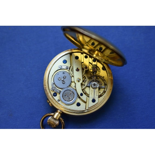 74 - An 18k gold open faced pocket watch, stem wound, having chased gold dial, 3cm.